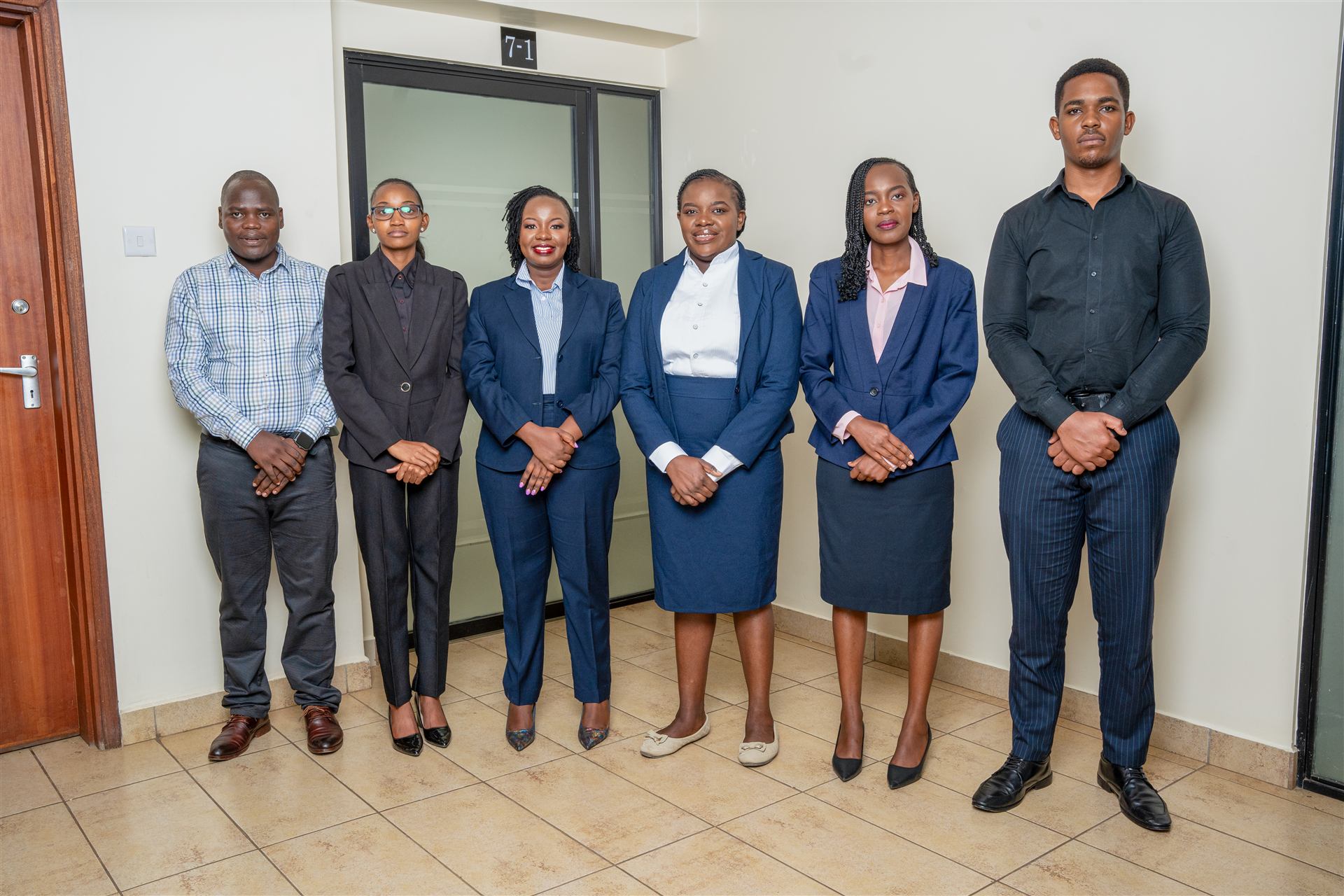 Wacuka Kihenjo team standing in office